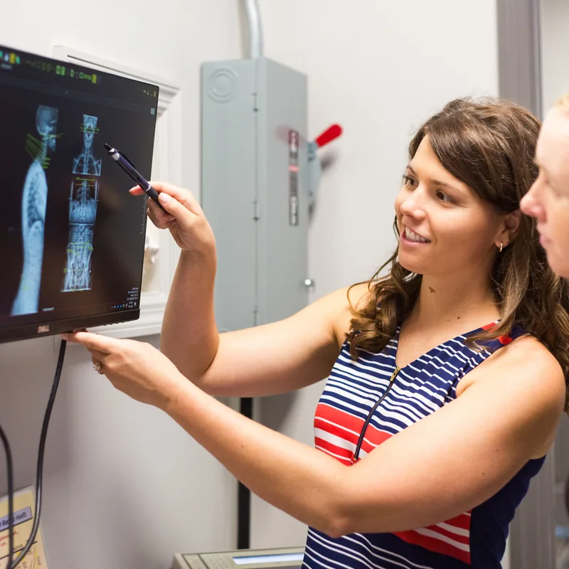 Dr. Noonan reviewing a spinal X-ray at Full Circle Health