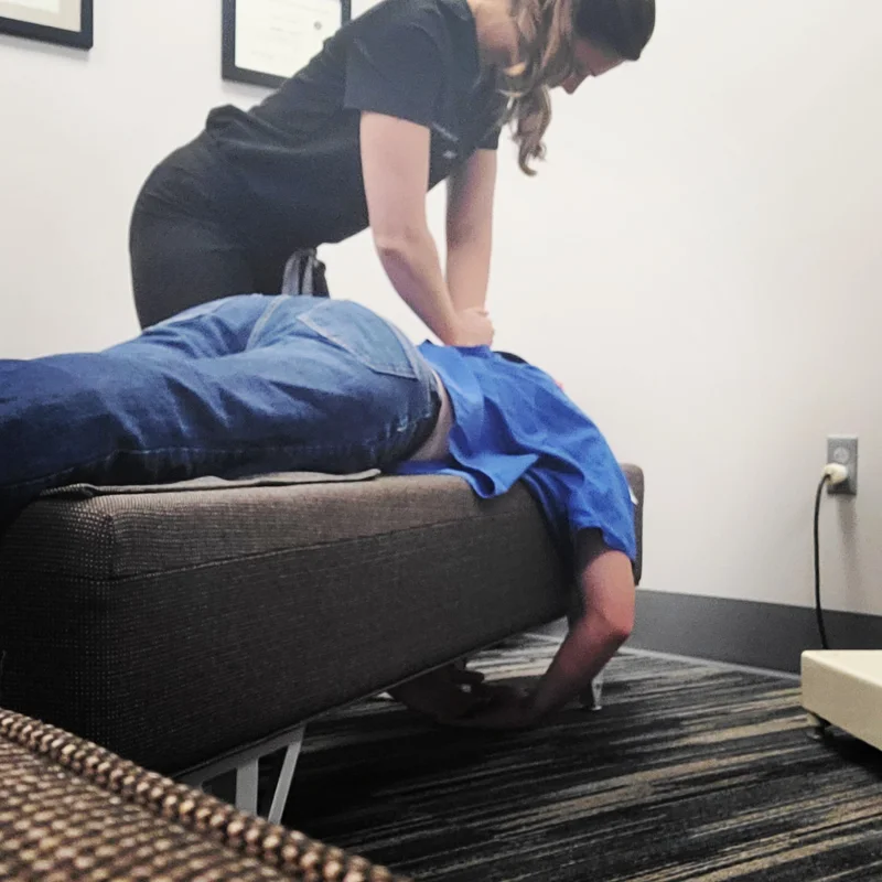 Dr. Emily Noonan performing a chiropractic adjustment on a patient at Full Circle Health