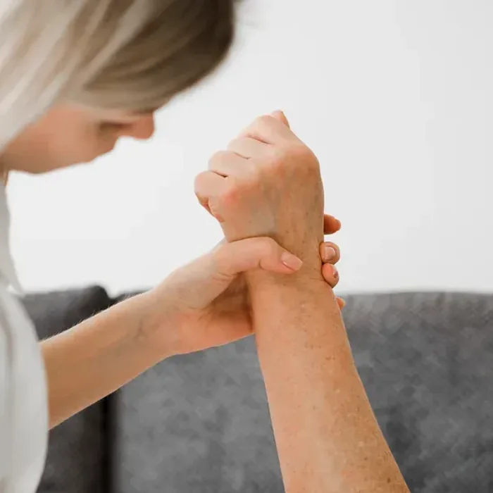 Clinician assessing a patient’s wrist and forearm