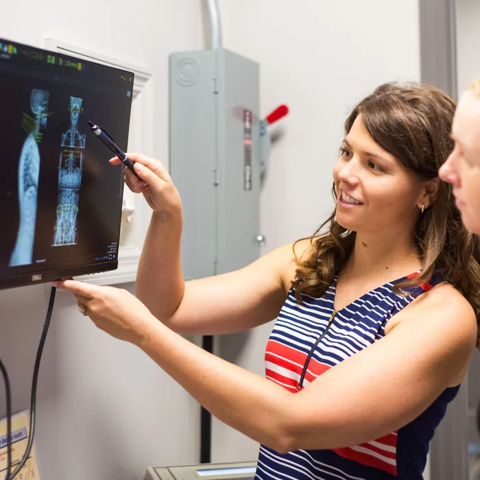Dr. Noonan showing a patient their spinal X-rays