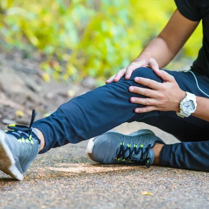 Clinician treating a runner’s knee outdoors