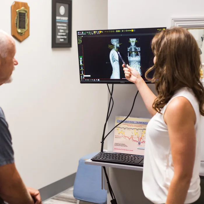 Dr. Noonan reviewing a patient’s spinal X-rays at Full Circle Health