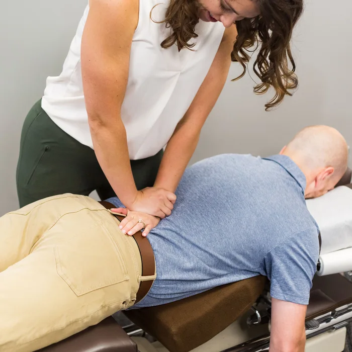 Dr. Noonan performing a low back adjustment for sciatic nerve pain