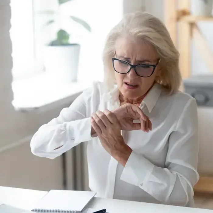 Patient holding a stiff, catching finger